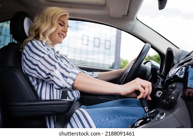 Cheerful Blonde Beginner Driving Car During Course