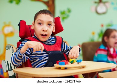 Cheerful Boy With Disability At Rehabilitation Center For Kids With Special Needs