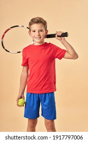 Cheerful Boy Holding Tennis Racket And Ball