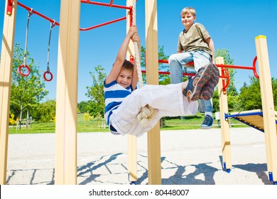 Cheerful boy swinging on rope - Powered by Shutterstock