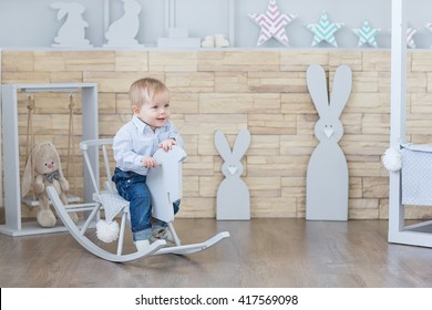 Cheerful Boy Toddler Baby Swinging On A Rocking Chair In The Shape Of A Horse.