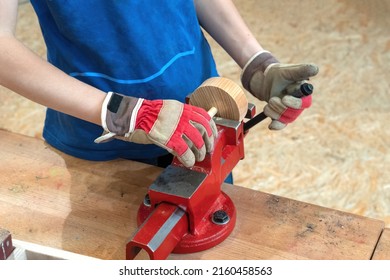 Cheerful boy is using hand instruments and trying making products from desk