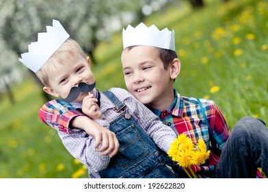 Cheerful boys with a paper crowns on their head - Powered by Shutterstock