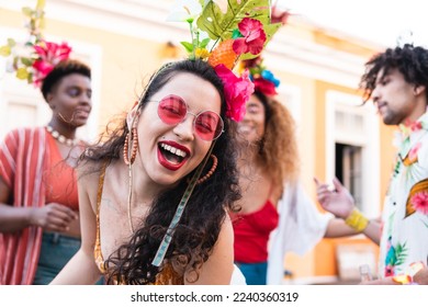 Cheerful brazilian woman laughing and dancing in the street. Brazil Carnaval festival and people in costume celebrating. - Shutterstock ID 2240360319