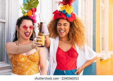 Cheerful brazilian women having fun at street Carnival. Carnaval in Brazil, girls celebrating and toasting party together. - Shutterstock ID 2240360311