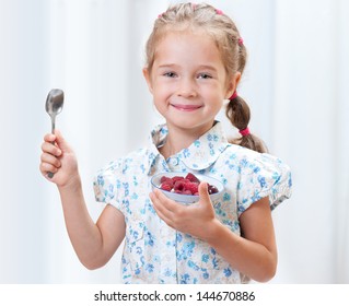 Cheerful breakfast. A plate with cottage cheese and berries on the table