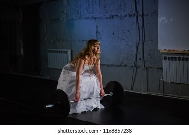 Cheerful Bride With Big Muscles With A Barbell In The Gym Doing Exercise.