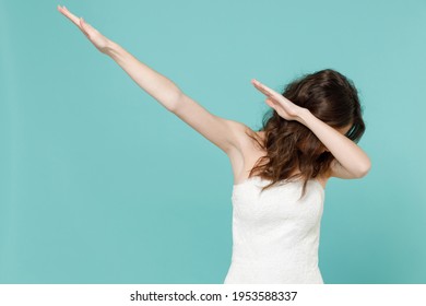 Cheerful Bride Young Woman In White Wedding Dress Doing Dab Hip Hop Dance Hands Move Gesture Youth Sign Hiding Covering Face Isolated On Blue Turquoise Background. Ceremony Celebration Party Concept