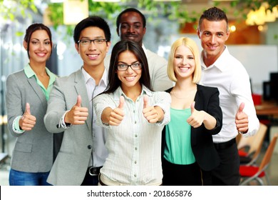Cheerful Business Group Giving Thumbs Up