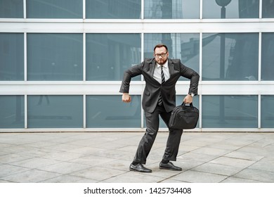 Cheerful Business Man Dancing Near The Office Building On The Street.