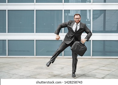 Cheerful Business Man Dancing Near The Office Building On The Street.