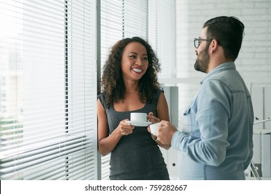 Cheerful Business People Drinking Coffee And Talking During Short Break