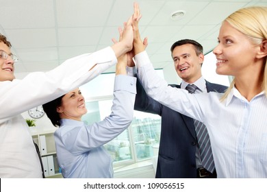 Cheerful Business Team Holding Their Hands Together With Enthusiasm