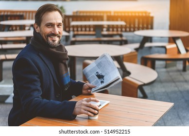 Cheerful businessman resting in cafe outside - Powered by Shutterstock