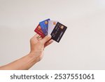 cheerful businessman sits at his desk, using a laptop to make an online purchase. With a credit card in hand, he connects to e-commerce, enjoying seamless technology and finance solutions.