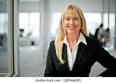 Cheerful businesswoman in the office. - Shutterstock ID 1287466291