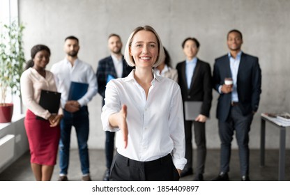 Cheerful Businesswoman Stretching Hand For Handshake Greeting To Camera Making Career Offer Standing In Modern Office. Recruitment And Employment, Human Resources, Join Our Team Concept - Powered by Shutterstock