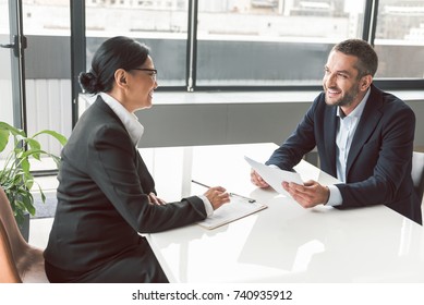 Cheerful businesswoman telling with male