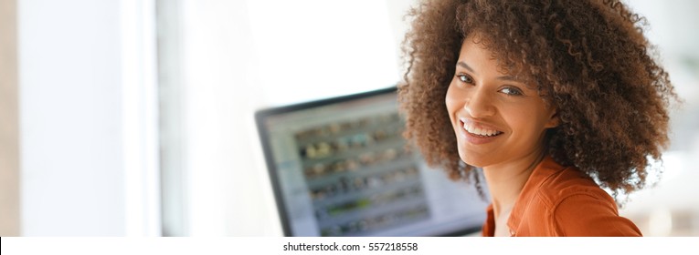 Cheerful businesswoman working on desktop computer