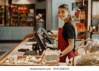 A cheerful cashier smiles in a vibrant grocery store filled with fresh products and happy customers