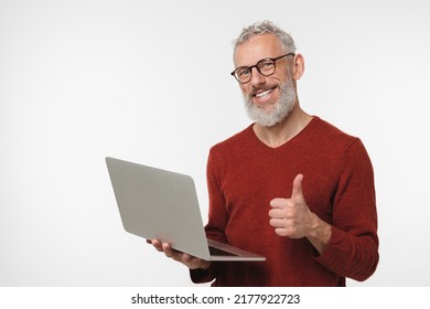 Cheerful Caucasian Mature Middle-aged Freelancer Businessman Ceo Manager Using Laptop For Online Shopping, Remote Work, E-learning E-commerce Showing Thumb Up Isolated In White