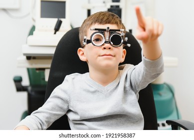 Cheerful Child Boy In Glasses Checks Eye Vision Pediatric Ophthalmologist.