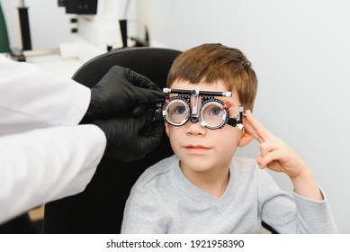 Cheerful Child Boy In Glasses Checks Eye Vision Pediatric Ophthalmologist.