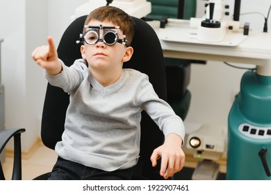 Cheerful Child Boy In Glasses Checks Eye Vision Pediatric Ophthalmologist.