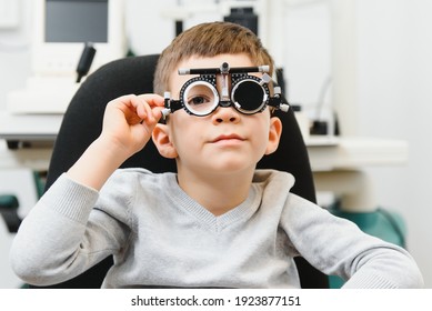 Cheerful Child Boy In Glasses Checks Eye Vision Pediatric Ophthalmologist.