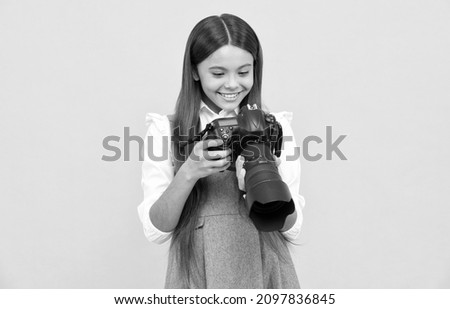 cheerful child girl take photo with digicam, photography