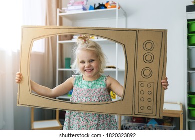 Cheerful Child Playing With Cardboard Tv At Home. Future Dream Profession Concept