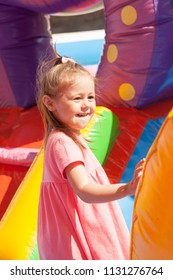 A cheerful child plays in an inflatable castle - Shutterstock ID 1131276764