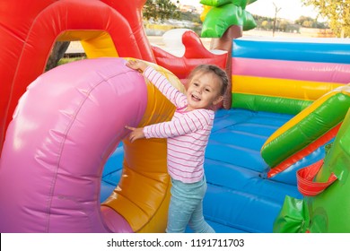A cheerful child plays in an inflatable castle - Shutterstock ID 1191711703