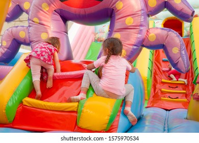 A cheerful child plays in an inflatable castle - Shutterstock ID 1575970534