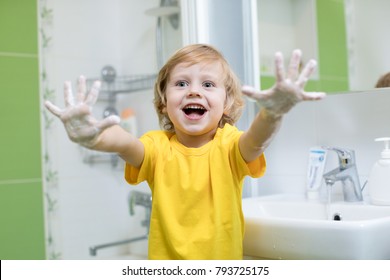 Cheerful Child Washing Hands And Showing Soapy Palms