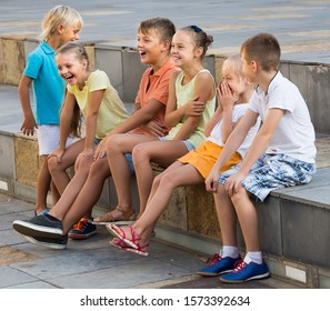 Cheerful Children In School Age Playing Charades Outdoors