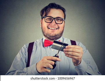 Cheerful Chunky Man Cutting Credit Card Paying Out All Debts. 