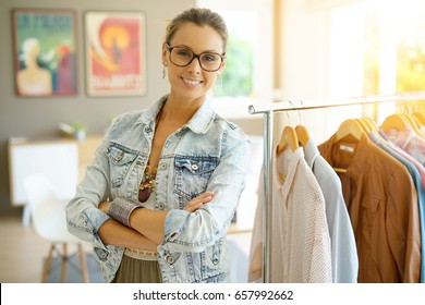 Cheerful Clothing Salesperson Standing In Shop