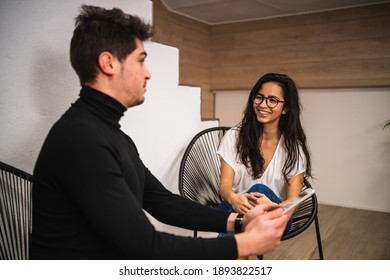 Cheerful Colleagues Discussing Data On Tablet