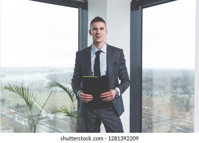 Cheerful Confident Young Trainee In Law Firm Standing In An Office And Posing Ready To Learn And Work