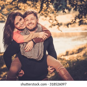 Cheerful couple in autumn park having fun - Shutterstock ID 318526097