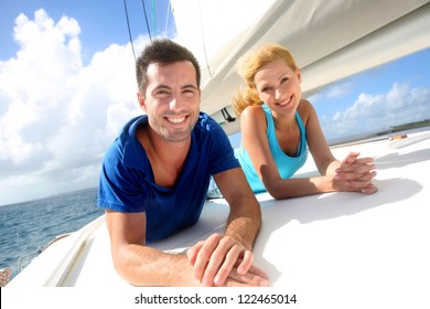 Cheerful Couple Cruising On A Sail Boat