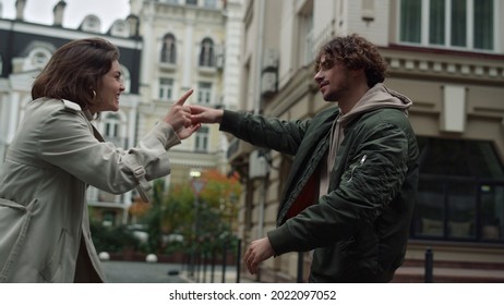 Cheerful Couple Dancing On Urban Street In Spring Day. Young Woman Spending Time With Boyfriend Outside. Affectionate Boyfriend And Girlfriend Having Fun In Old Town.