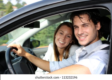 Cheerful Couple Driving Car