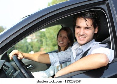 Cheerful Couple Driving Car