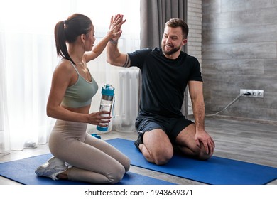 Cheerful Couple Give High Five To Each Other After Successful Intense Workout Training At Home