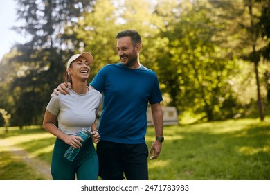 Cheerful couple having fun while exercising in nature. Copy space.  - Powered by Shutterstock