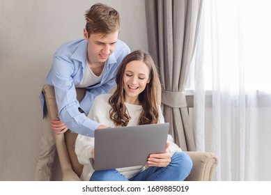 Cheerful Couple Looking At Laptop Computer, Together On Day And Weekend Off At Home. Choose Film, Building Family Financial Plan, Meal Planning For Healthy Style, Wedding Ideas, Ordering Gifts, Online