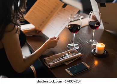 Cheerful couple with menu in a restaurant making order - Shutterstock ID 674037814