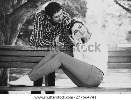 Similar – Joyful couple laughing together on a vintage sofa